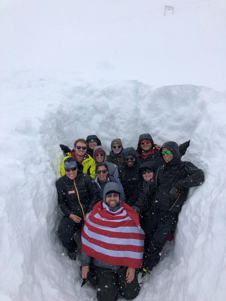 Researchers in a huge snow bank.