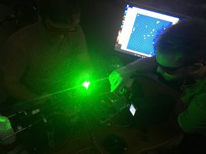 UA researcher using a green laser