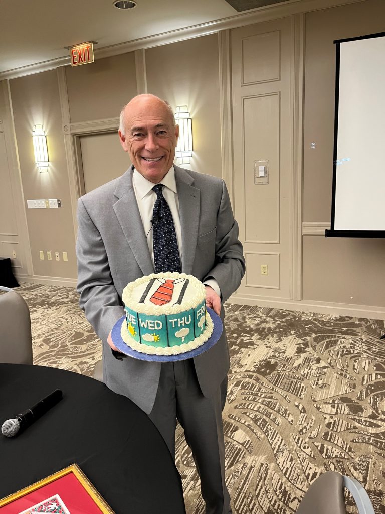 Photo of James Spann accepting a thank you cake.