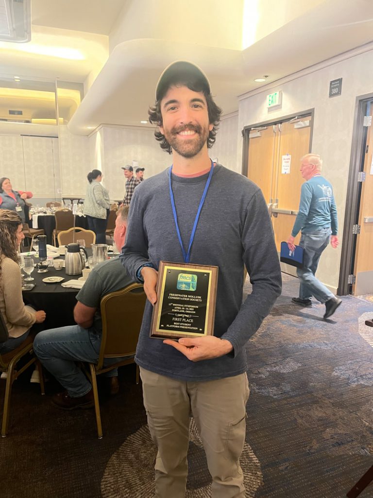Matt Lodato with his award at the Freshwater Mollusk Conservation Society meeting.